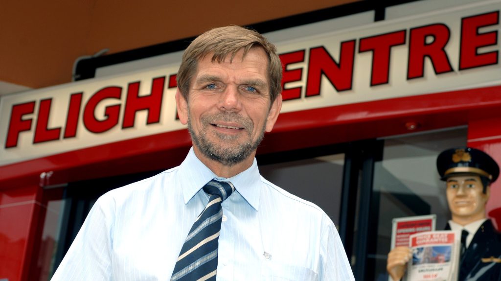 Flight Centre managing director Graham Turner outside a travel agency in Brisbane. (AAP Image/Dave Hunt) NO ARCHIVING