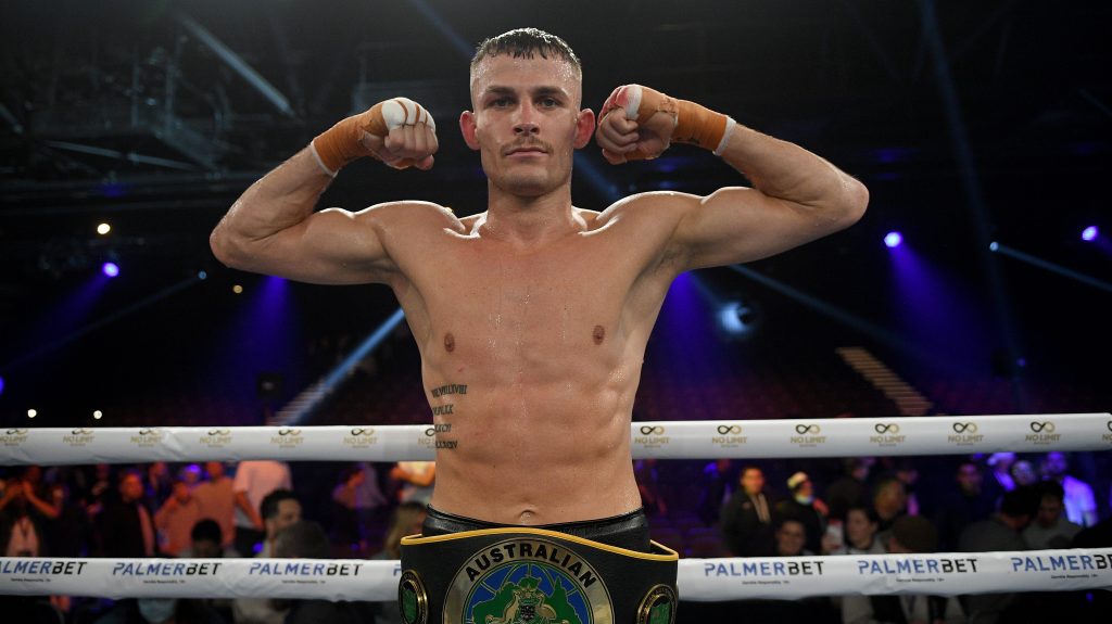 Harry Garside poses for a photograph with his title belt  (AAP Image/Dan Himbrechts). 
