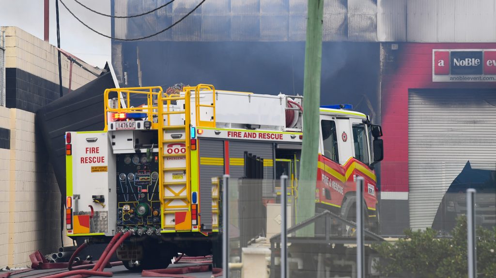 A damaged building at Freedom Pools, at the scene of a factory fire in Slacks Creek, in Logan, QLD, Tuesday, 2023. (AAP Image/Jono Searle)