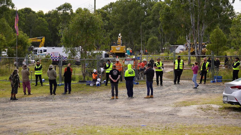 A supplied image shows police clearing protesters from a camp near the Deebing Creek Mission site near Ipswich, Queensland, Tuesday, May 2, 2023. A protester has been arrested at a proposed development at the Deebing Creek Aboriginal massacre site near Ipswich during a dawn police operation. (AAP Image/Supplied by Deebing Creek Justice)