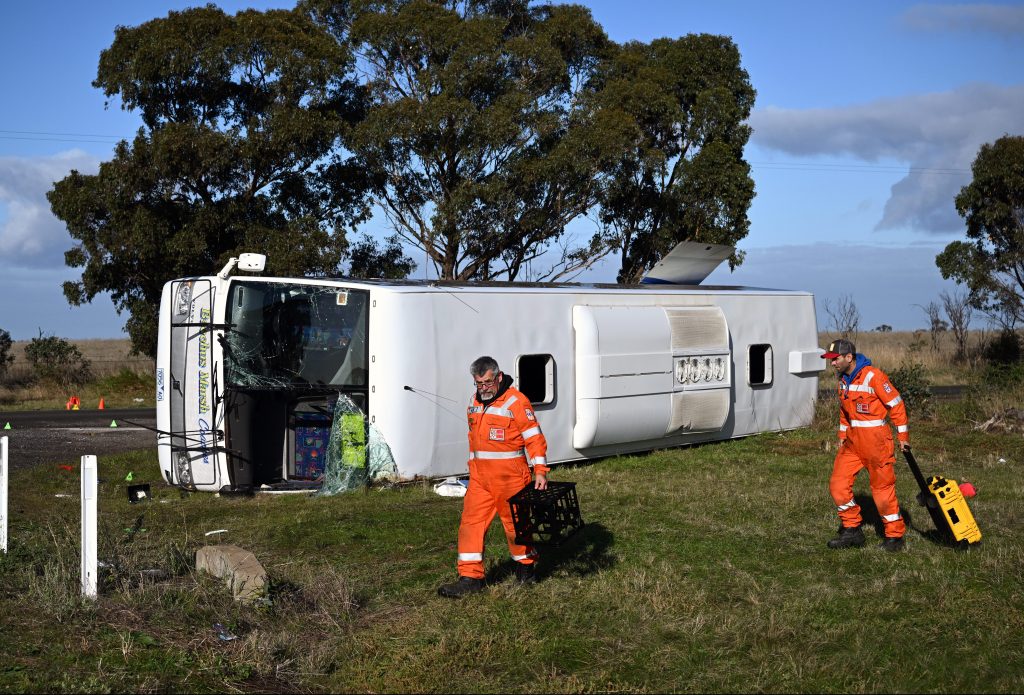 Emergency Services at the scene of a bus crash at the intersection of Exford Road and Murphys Road at Eynesbury, in Melbourne. On Tuesday, a bus carrying dozens of children collided with a truck in Melbourne's west, . (AAP Image/Joel Carrett) 