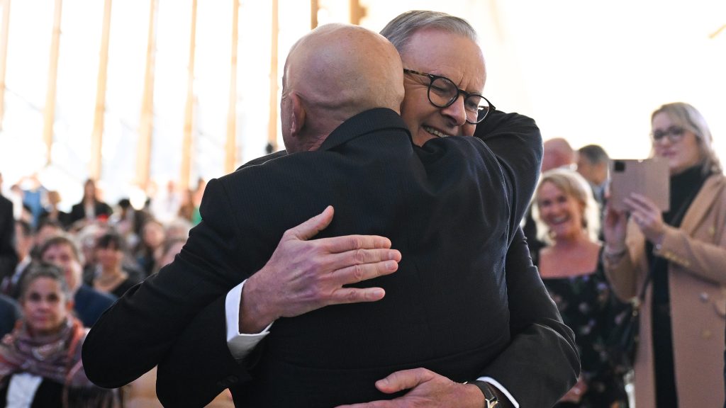 Walter Mikac hugs Australian Prime Minister Anthony Albanese during an event at the National Museum of Australia in Canberra, Thursday. The National Museum of Australia will receive letters from Walter Mikac to John Howard, which played a crucial role in driving nationwide reforms on gun control in Australia. (AAP Image/Lukas Coch) 