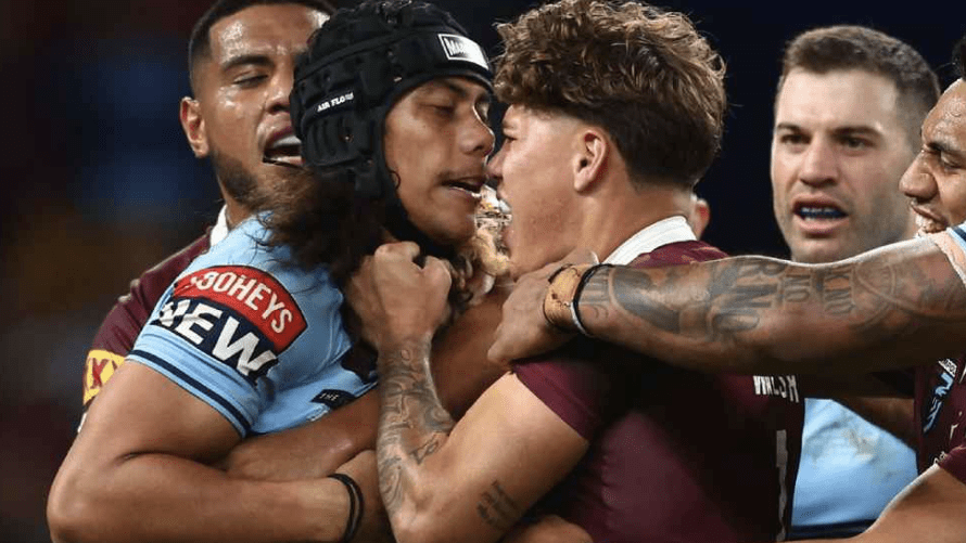 Jarome Luai of the Blues and Reece Walsh of the Maroons scuffle before being sent off for head butting. Chris Hyde/Getty Images