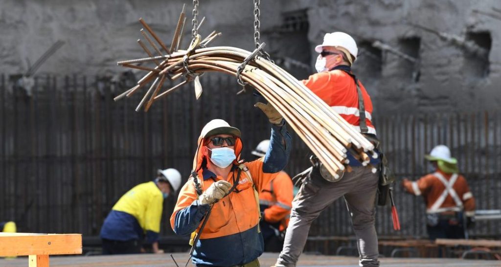 Construction workers are seen working at the Roma Street Station on the Cross River Rail project in Brisbane, Saturday, February 12, 2022.   (AAP Image/Darren England) 