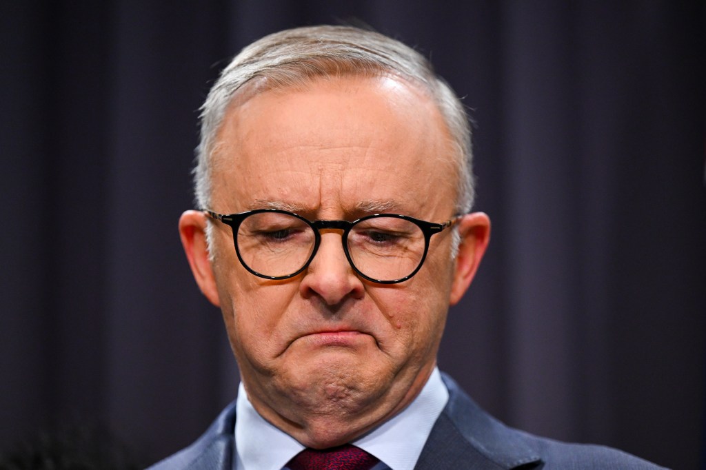 Australian Prime Minister Anthony Albanese surrounded by members of the First Nations Referendum Working Group gets emotional as he speaks to the media during a press conference. The failure of the referendum is just one of the things that clouded his year. (AAP Image/Lukas Coch) 