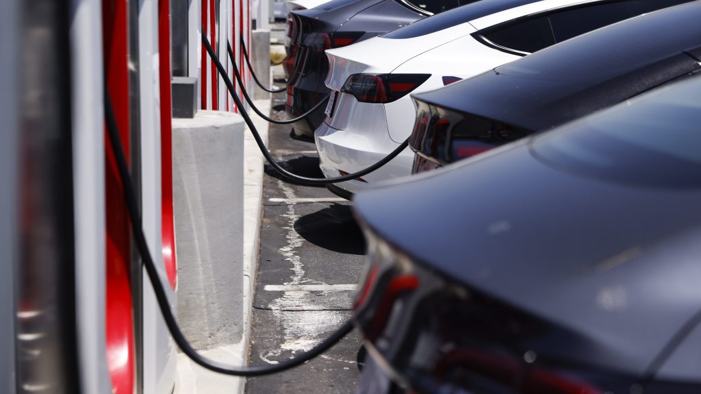 Tesla electric vehicles charge at a supercharger station in Hawthorne, California, (EPA/CAROLINE BREHMAN)