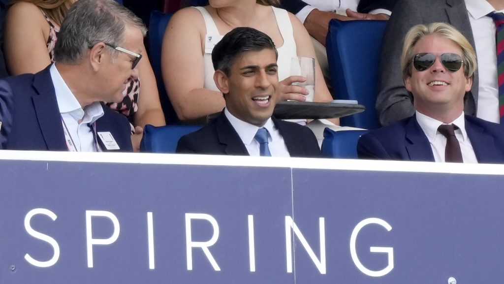 Britain's Prime Minister Rishi Sunak, center, watches the play on the fourth day of the second Ashes Test match between England and Australia, at Lord's cricket ground in London, Saturday, July 1, 2023. (AP Photo/Kirsty Wigglesworth)