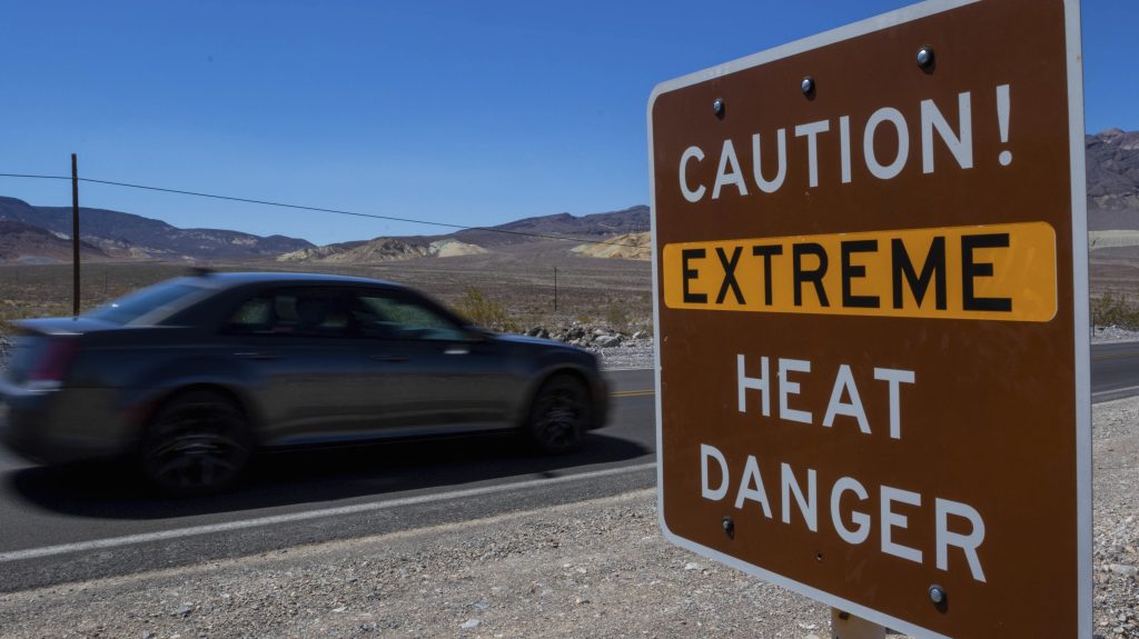 A sign stands warning of extreme heat Tuesday in Death Valley National Park, Calif. July is the hottest month at the park with an average high of 116 degrees (46.5 Celsius). (AP Photo/Ty ONeil)