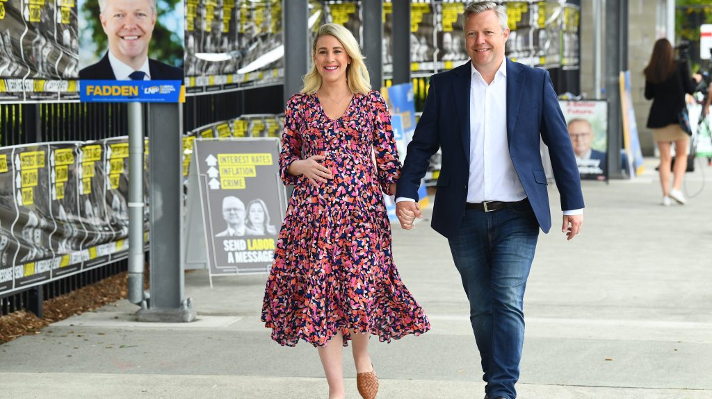 LNP's Cameron Caldwell and wife Lauren are seen during polling day for the by-election in the federal Queensland seat of Fadden, on the Gold Coast. (AAP Image/Jono Searle)
