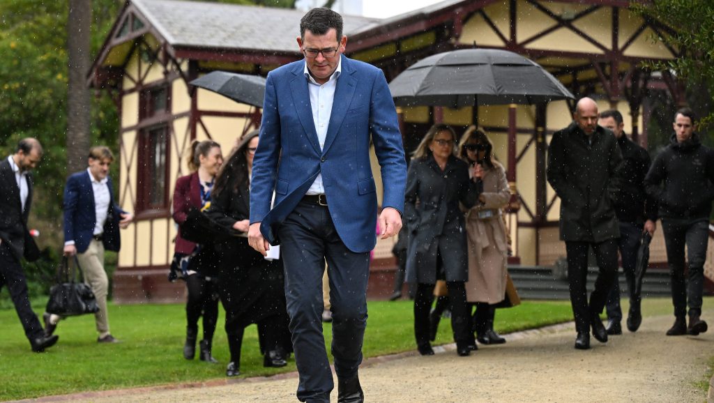 Victorian Premier Daniel Andrews cuts a lonely figure as he departs from a press conference to announce he has cancelled the 2026 Commonwealth Games, slated to be held across Victoria. (AAP Image/James Ross)