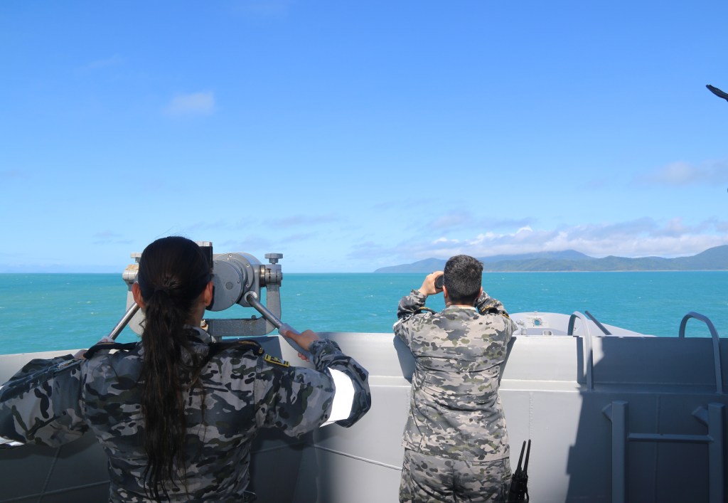 A supplied image obtained Sunday, July 30, 2023. Royal Australian Navy sailors from HMAS Brisbane on the bridge wing scan the horizon during search and rescue operations in the vicinity of Lindeman Island, Queensland, 29 July 2023. A multi-national and multi-agency search and rescue effort is underway following an Australian Army MRH-90 Taipan helicopter impacting waters near Lindeman Island on the night of 28 July 2023 during Exercise Talisman Sabre 23. (AAP Image/Defence Imagery) NO ARCHIVING, EDITORIAL USE ONLY