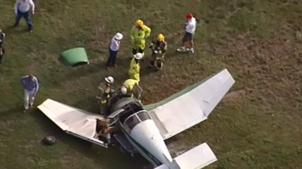 Emergency crews at the wreckage of one of two planes that collided mid-air at Caboolture Airport. (Channel 9 image)