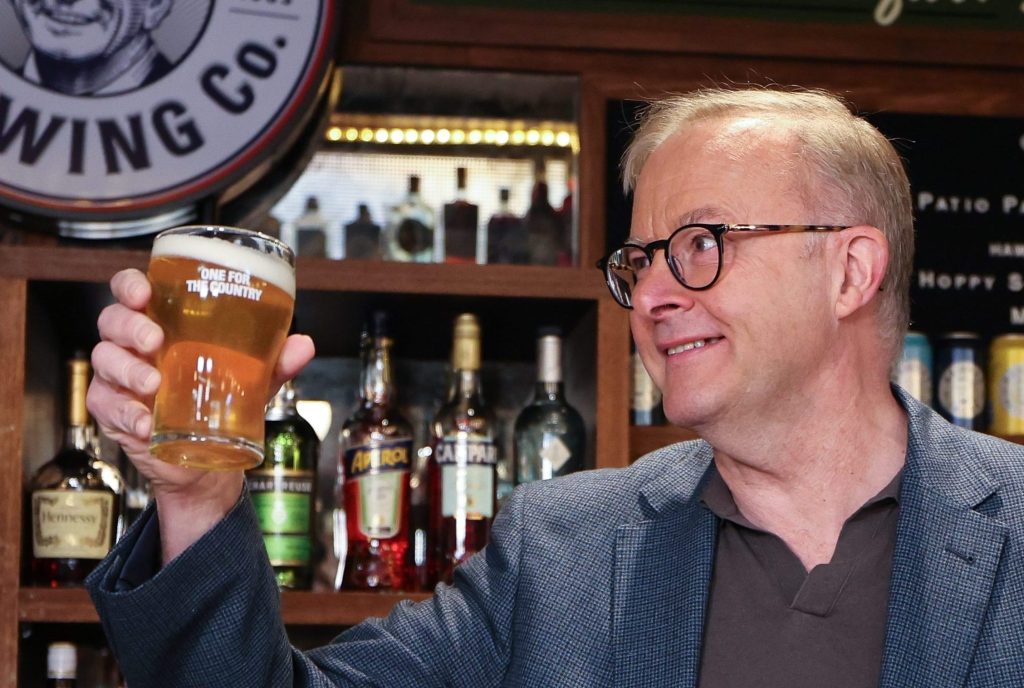 Australian Prime Minister Anthony Albanese reacts after pouring a ‘Hawkes Lager’ at the new Bob Hawke Beer and Leisure Centre in Sydney (AAP Image/Paul Braven) 