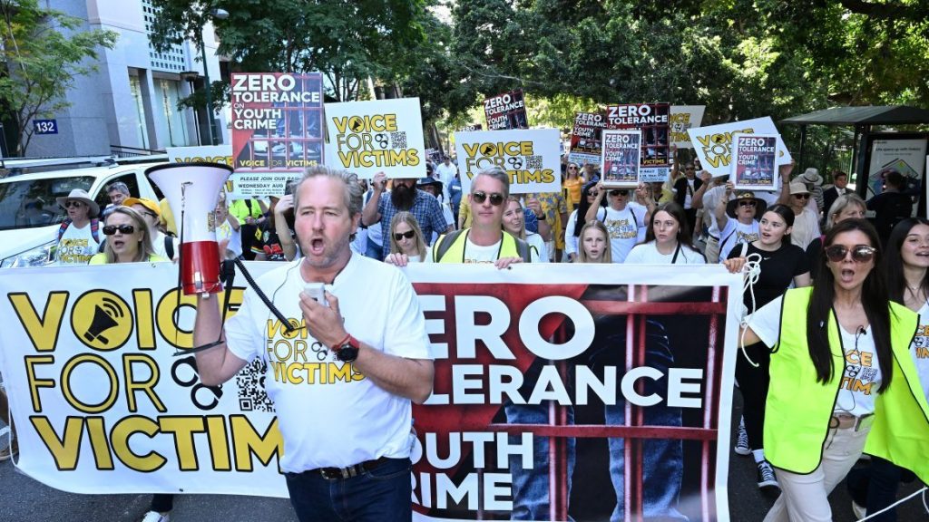Ben Cannon leads protestors during a Voice for Victims community group rally in Brisbane, Wednesday, August 23, 2023. Victims of crime and their supporters held a rally to protest Queensland’s youth crime rates and the justice system.  (AAP Image/Darren England) NO ARCHIVING