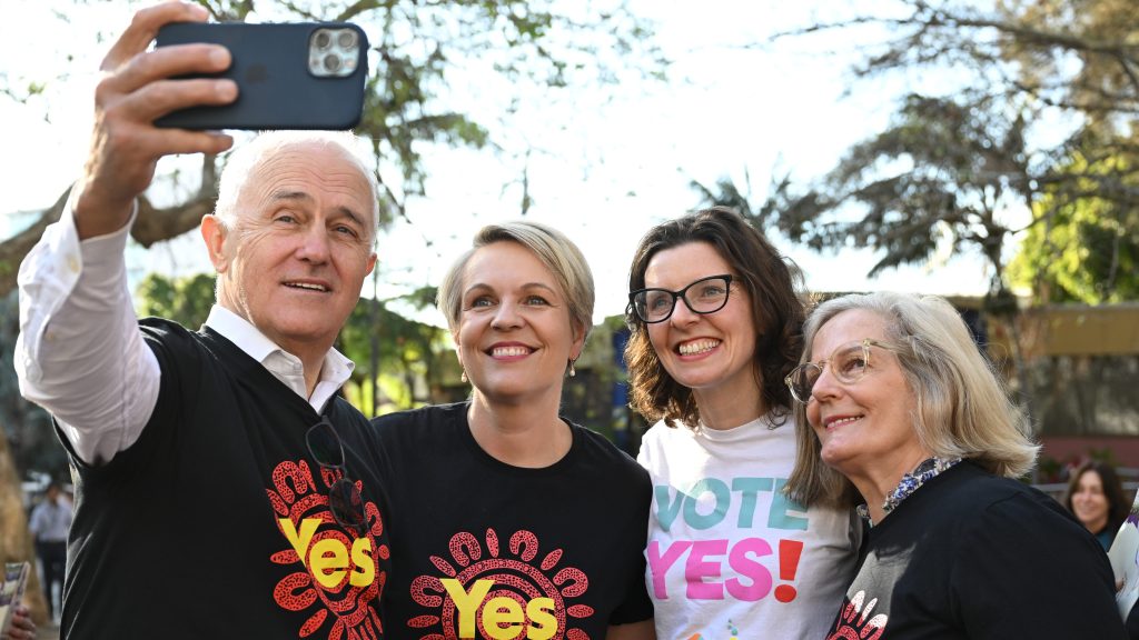 ( Former prime minister Malcolm Turnbull takes a selfie with Federal Minsiter for the Envrioment Tanya Plibersek, Federal member for Wentworth Allegra Spender and Lucy Turnbull ias they hand out Yes campaign material for the Voice in Kings Cross.  (AAP Image/Dean Lewins) 