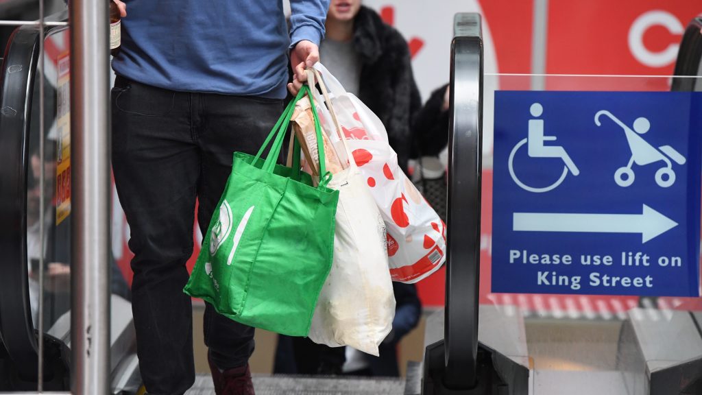 A shopper is seen carrying bags at a Coles Sydney CBD store, Sydney, Monday, July 2, 2018. Woolworths says it will hand out free reusable bags for the next 10 days as its customers get used to its ban on single-use plastic bags. Woolies stores in NSW, Queensland, Victoria and Western Australia stopped providing free single-use plastic bags on June 20. (AAP Image/Peter RAE) NO ARCHIVING