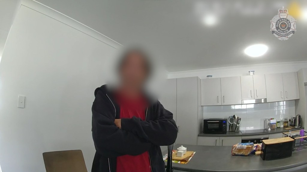 A man being placed under arrest for the possession and distribution of child exploitation material in Queensland. Queensland detectives have charged six men with dozens of child sex offences, including allegedly filming girls in public toilets. (AAP Image/Supplied by Queensland Police)