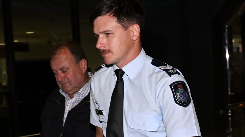 Senior Constable Tylarr Colman (right) is seen leaving the Inquest into the death of Steven Lee Nixon-McKellar at the Toowoomba Courthouse. (AAP Image/Darren England) 