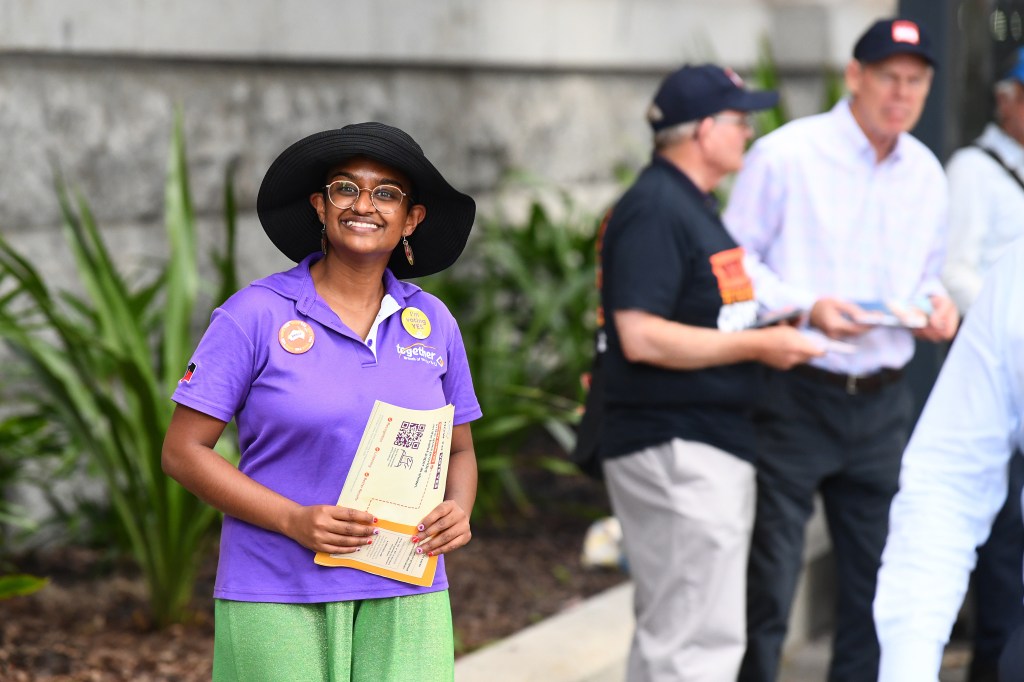Voters and volunteers are seen at Brisbane City Hall, during early voting for the Indigenous voice to parliament referendum in Brisbane, Tuesday, October 3, 2023. (AAP Image/Jono Searle) NO ARCHIVING