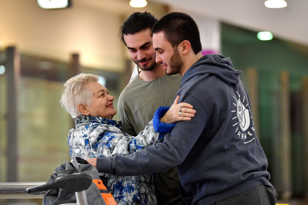 People embrace as Australian nationals arrive on a repatriation flight at Sydney International Airport, Wednesday, October 18, 2023. More than 200 Australians evacuated from Israel have arrived home, as the government looks to secure safe passage for those stuck in Gaza. (AAP Image/Bianca De Marchi) NO ARCHIVING