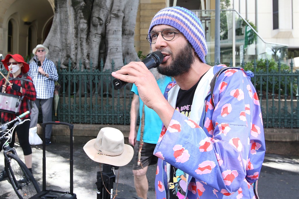 Greens Councilor Jonathan Sri speaks during a Climate action march on parliament house during a protest in Brisbane, Thursday, December 2, 2021. (AAP Image/Jono Searle) NO ARCHIVING