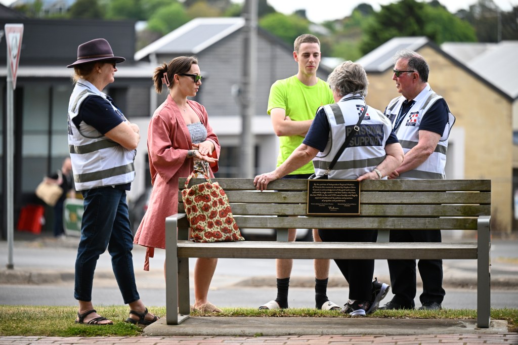 Personal support workers are seen speaking to people at the scene of a car crash in Daylesford, Victoria, Monday, November 6, 2023. Five people, including two children, have died and there are multiple others injured after an SUV car crashed into a pub in regional Victoria. (AAP Image/James Ross) NO ARCHIVING