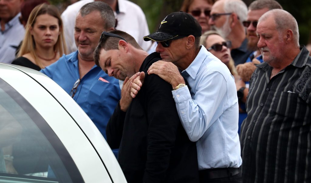 Corey Richards, stepson of Alan Dare, reacts at the funeral of the "good Samaritan" neighbour killed in Wieambilla shootings (AAP Image/Jason O'Brien) 