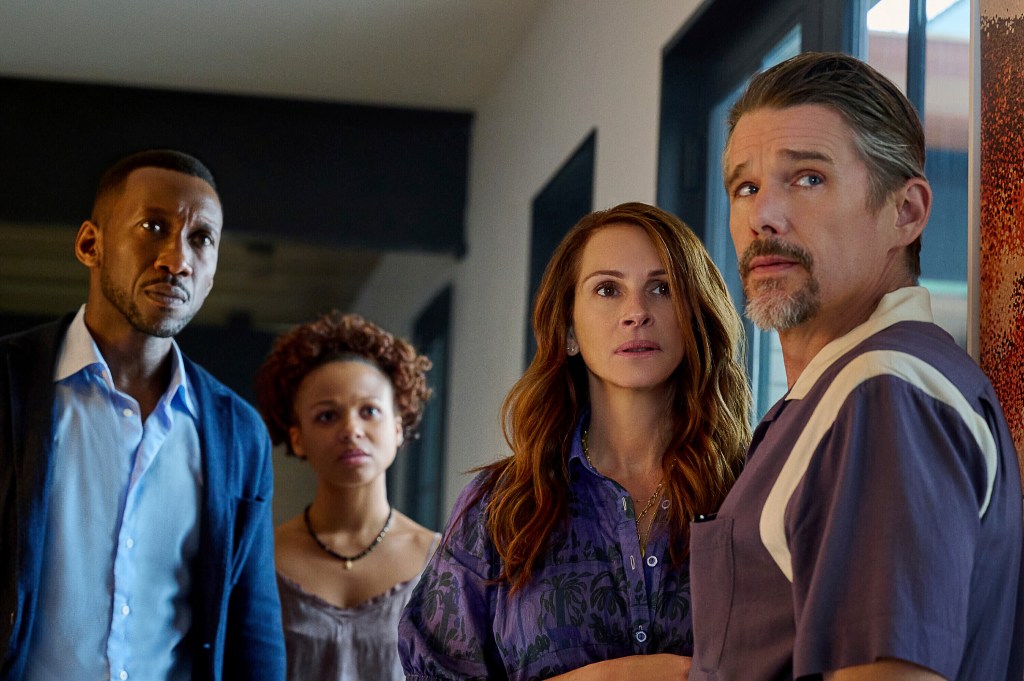 Mahershela Ali, Myha'la Herrold, Julia Roberts and Ethan Hawke in a scene from "Leave the World Behind." (JoJo Whilden/Netflix via AP)
