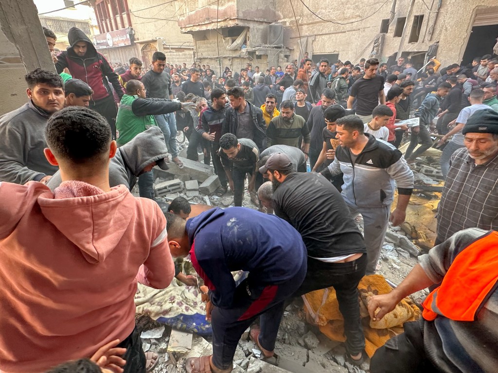 Palestinians assess damage caused by Israeli airstrikes. Federal minister Ed Husic says Australians should be able to express their views on violence in Palestine without fear of being blacklisted. (Youssef Mohammed/TASS/Sipa USA)
