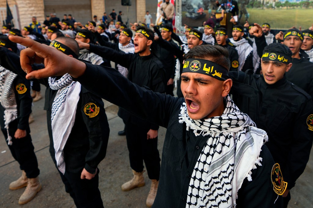 Palestinian members of Al-Quds Brigades, the military wing of the Islamic Jihad group, chant slogans during a protest in solidarity with the Palestinian people in Gaza, at Bourj al-Barajneh Palestinian refugee camp, in Beirut,  (AP Photo/Bilal Hussein)