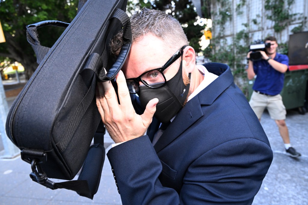 Brett Robert Jenkins is seen leaving the Brisbane District Court in Brisbane, Monday, December 18, 2023.  Bruce John Jenkins, 68, and son Brett Robert Jenkins, 39, have been sentenced for defrauding hundreds of country music fans by selling fake travel packages. (AAP Image/Darren England) 