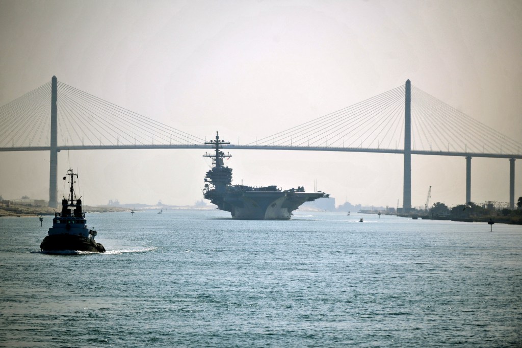 Nimitz-class aircraft carrier USS George H.W. Bush (CVN 77) passes under the Friendship Bridge while transiting the Suez Canal. U.S. Navy Photo by Mass Communication Specialist 2nd Class Tony D. Curtis via ABACAPRESS.COM.