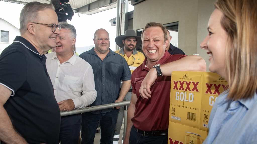 Prime Minister Anthony Albanese (left) and Queensland Premier Steven Miles gift Ergon Energy workers pallets of XXXX beer for their efforts in the aftermath of Cyclone Jasper. (AAP Image/Brian Cassey) 