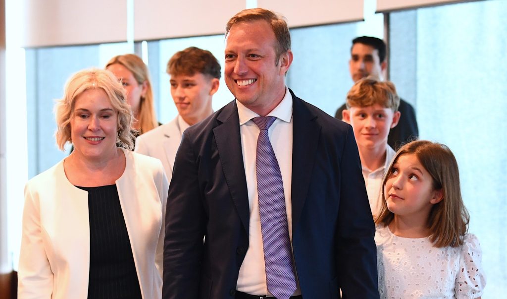 New Queensland Premier Steven Miles (centre) arrives with wife Kim, (left) and family as he makes his first address as Premier, at 1 William Street in Brisbane, Friday, December 15, 2023. (AAP Jono  Searle) 