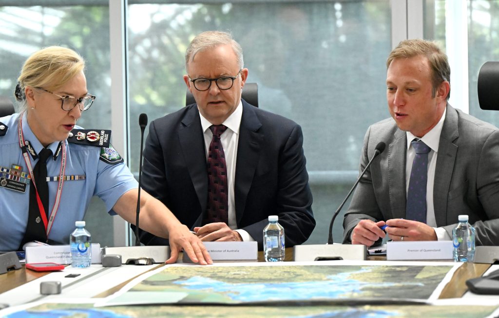 Police Commissioner Katarina Carroll, Australian Prime Minister Anthony Albanese and Queensland Premier Steven Miles are seen during a briefing at the State Disaster Coordination Centre in Brisbane,. (AAP Image/Darren England)