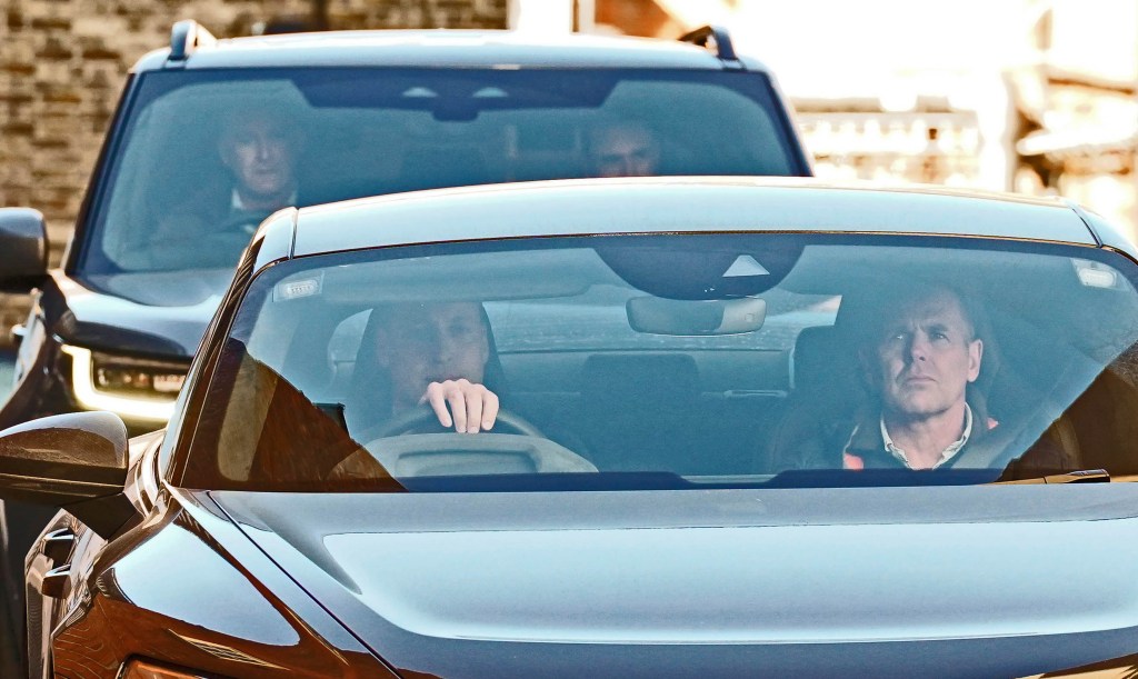 Britain's Prince William, left, drives away from the London Clinic, in central London, where Kate, the Princess of Wales is recovering after undergoing successful abdominal surgery. (Lucy North/PA via AP)