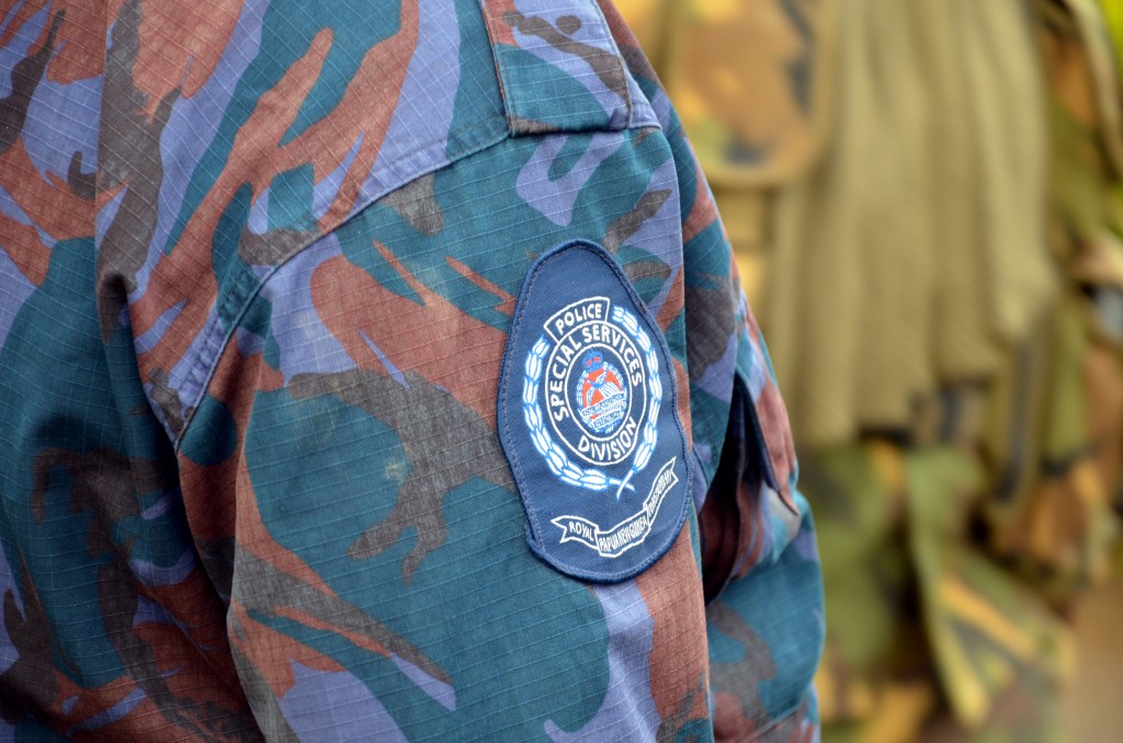 A police officer stands guard in Papua New Guinea on Friday, June 22, 2012. Voting in the 2012 election began on Saturday, June 23. (AAP Image/Eoin Blackwell) NO ARCHIVING