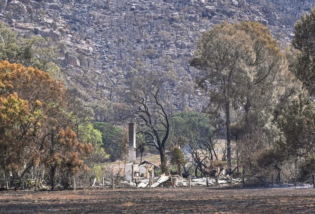 Fire damaged property is seen in Pomonal, Victoria, Thursday, February 15, 2024. Fire crews are hoping more favourable conditions will help extinguish three out-of-control bushfires in Victoria's west and central regions. (AAP Image/Pool/Justin McManus) NO ARCHIVING