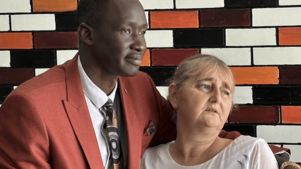 Queensland African Communities Council president Beny Bol with alleged murder victim Vyleen White's daughter Cindy.(ABC News: Michael Rennie)