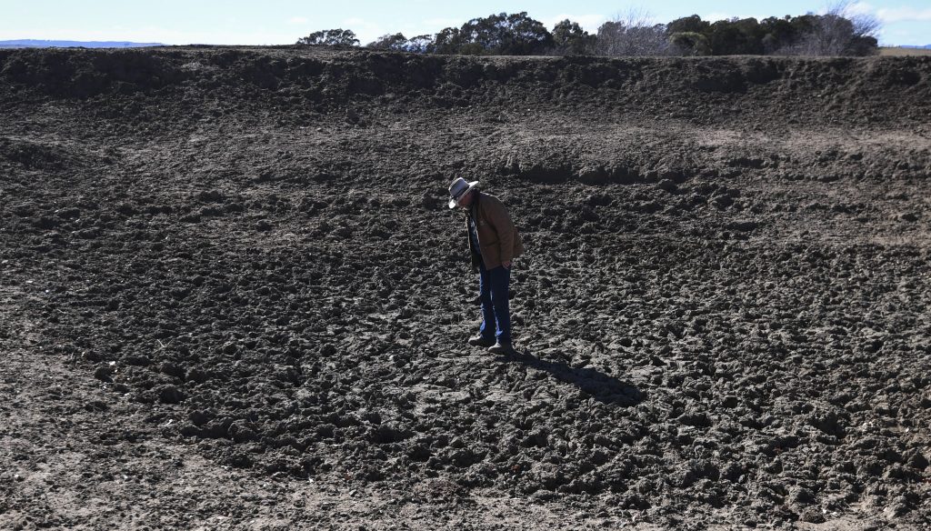 NSW farmer Mark Horan inspects a dried out dam on Bedervale farm near Braidwood, NSW (Photo Lukas Coch) 
