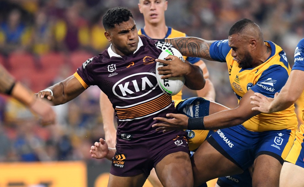 Tevita Pangai Junior (left)  of the Broncos is tackled by Junior Paulo (right) of the Eels during the Round 1 NRL match between the Brisbane Broncos and the Parramatta Eels at Suncorp Stadium. (AAP Image/Darren England) 