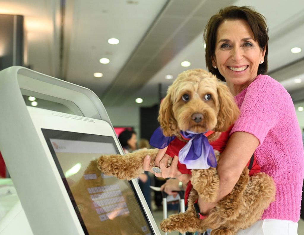 Virgin Australia CEO Jayne Hrdlicka  with a dog at the Virgin Domestic departures terminal at Melbourne Airport in Melbourne, . (AAP Image/James Ross) 