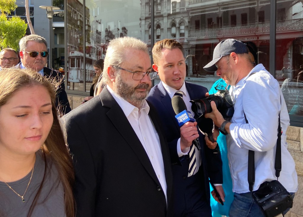 Bus driver Brett Button (centre) arrives at Newcastle Local Court,  Newcastle.  Button is accused of driving dangerously fast in fog through a roundabout moments before his bus tipped over and crashed into a guard rail near Greta in the NSW Hunter Valley on Sunday night. (AAP Image/Mark Russell) 