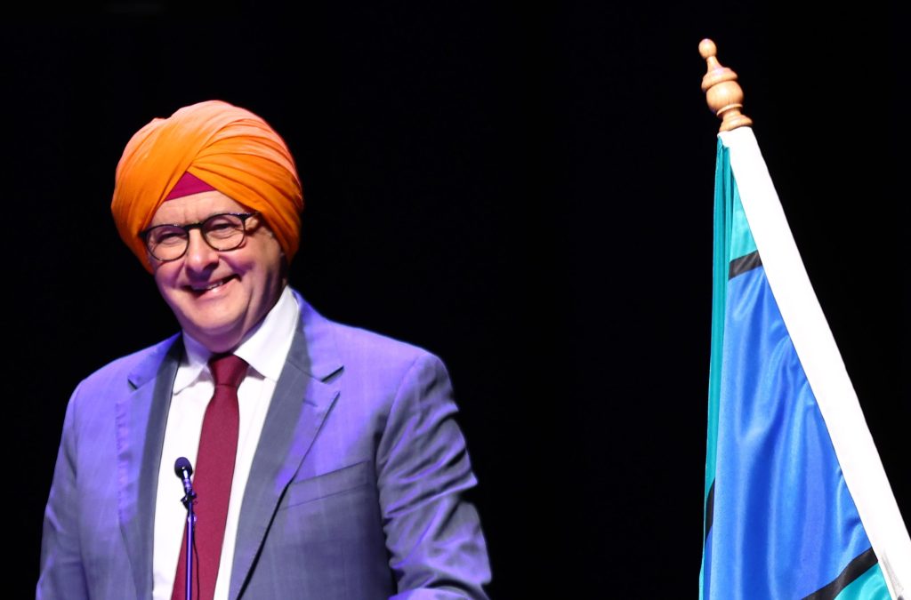 Australian Prime Minister Anthony Albanese speaks on stage during the 10th Anniversary celebrations of Sikh Volunteers Australia, Melbourne, Sunday, April 7, 2024.  The government has announced big cuts to migration while criticising the opposition's identical policy(AAP Image/ Con Chronis).