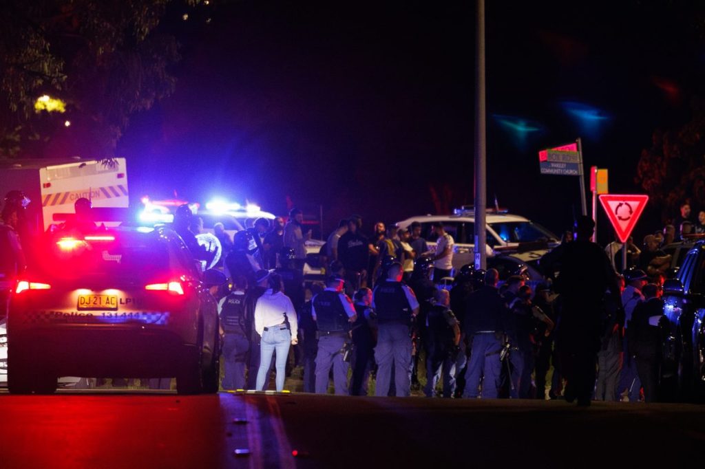 Police are seen following a stabbing at Christ The Good Shepherd Church in the suburb of Wakeley in Sydney, Monday, April 15, 2024. Police have pushed back an angry mob outside a church in Sydney's west after a bishop and three parishioners were stabbed during a service. (AAP Image/Paul Braven) NO ARCHIVING