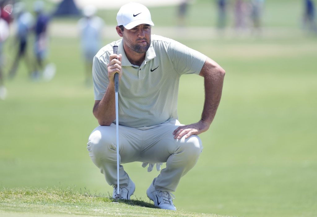 Scottie Scheffler looks at his putt line on the second hole during the final round of the Charles Schwab Challenge golf tournament at Colonial Country Club in Fort Worth, Texas, Sunday, May 26, 2024. (AP Photo/LM Otero