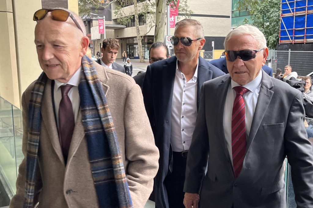 Former AFL footballer Barry Cable (right) arrives at Perth Magistrates Court, in Perth, Thursday, May 30, 2024. (AAP Image/Aaron Bunch) 