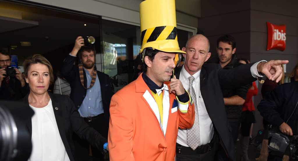 Chas Licciardello from The Chaser television comedy is escorted by security from the Coalition Campaign Launch in Sydney in 2016.  (AAP Image/Dan Himbrechts) 