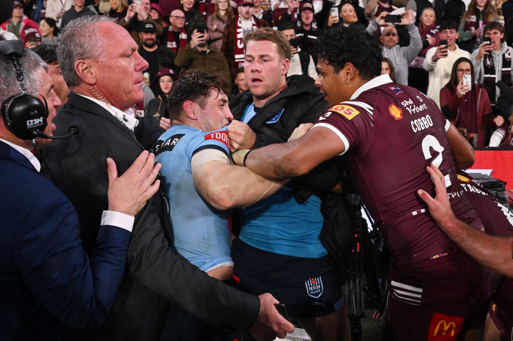 Cameron Murray of the Blues fights with Selwyn Cobbo of the Maroons on the sidelines during the State of Origin Game Three match between the Queensland Maroons and the New South Wales Blues at Suncorp Stadium in Brisbane, Wednesday, July 17, 2024. (AAP Image/Dave Hunt) NO ARCHIVING, EDITORIAL USE ONLY