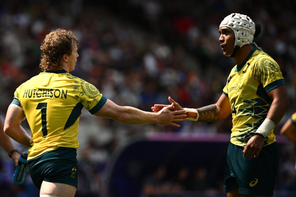Henry Hutchison of Australia (left) celebrates with Dietrich Roache after scoring a try during the Rugby Sevens Mens Pool B match between Australia and Samoa at the 2024 Paris Olympic Games in Paris, France, Wednesday, July 24, 2024. (AAP Image/Dan Himbrechts) NO ARCHIVING